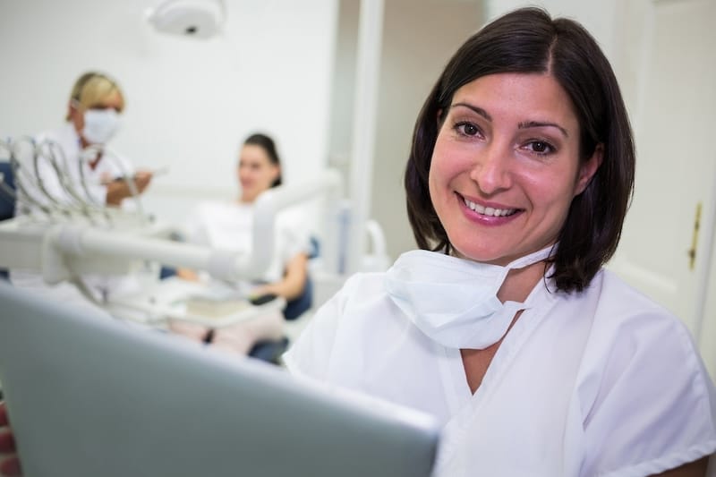 Portrait of smiling female dentist in dental clinic