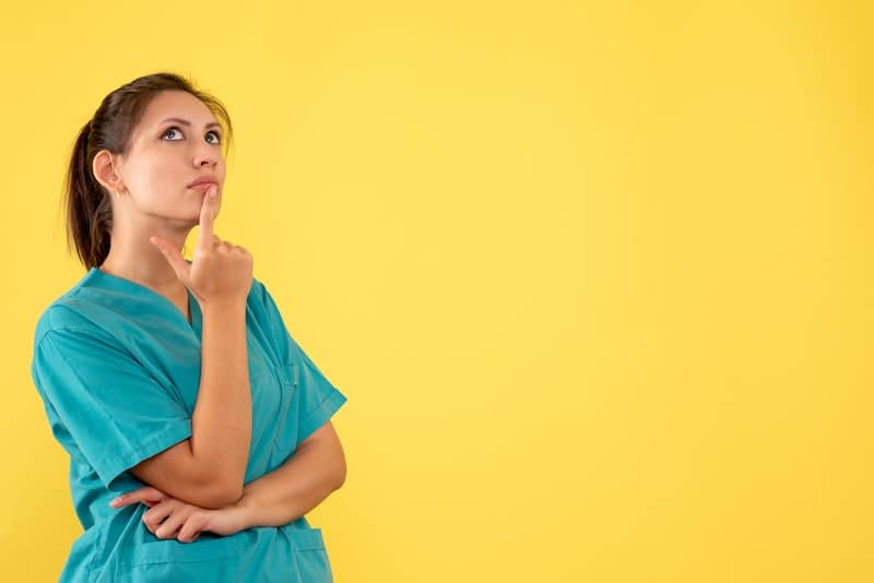 front view female doctor in medical shirt thinking on a yellow background health medic virus hospital nurse illness color