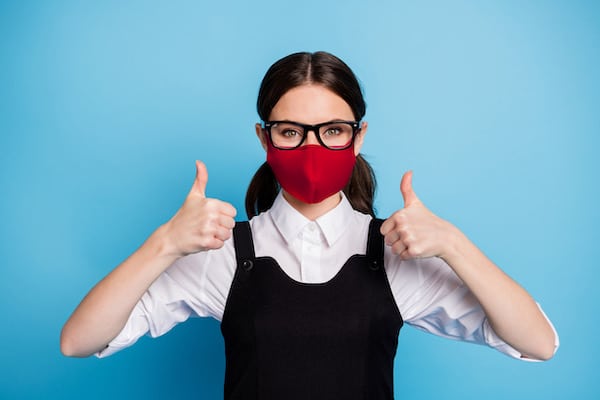 Close-up portrait of her she nice attractive intelligent healthy girl wearing safety red reusable textile mask stop mers cov influenza disease showing thumbup 2019 ncov isolated blue color background